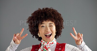 Buy stock photo Portrait, wink and happy woman with peace sign in studio for retro fashion on gray background. Excited, hand gesture or person with v symbol for victory, social media emoji or influencer with success