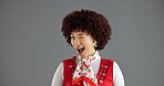 Happy, wink and portrait of woman in studio with trendy clothes, cool style and retro outfit. Mockup space, fashion and face of person with confidence, emoji gesture and flirting on gray background