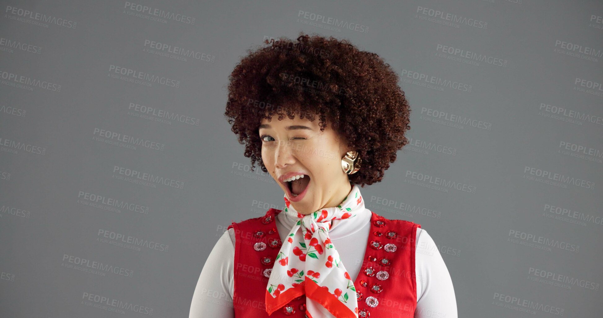 Buy stock photo Happy, wink and portrait of woman in studio with trendy clothes, cool style and retro outfit. Mockup space, fashion and face of person with confidence, emoji gesture and flirting on gray background