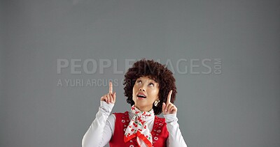 Buy stock photo Woman, pointing up and info in studio for advertising, announcement or news about us on gray background. Mockup space, presentation or coming soon with hand gesture, sign or direction for launch