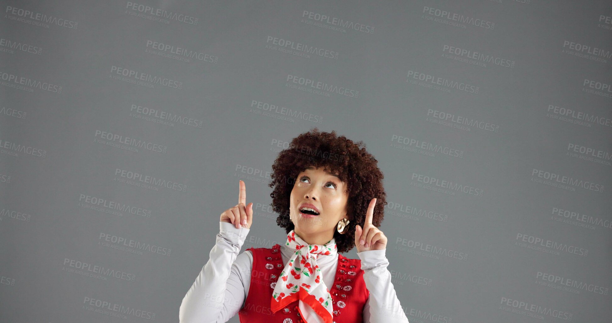 Buy stock photo Woman, pointing up and info in studio for advertising, announcement or news about us on gray background. Mockup space, presentation or coming soon with hand gesture, sign or direction for launch