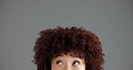Woman, face and eyes with thinking closeup, ideas or solution with problem solving for brainstorming in studio. Vision, dream or mindset for decision, person with afro and space on gray background