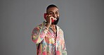 Telephone, fashion and happy black man in studio with trendy clothes, style and outfit. Vintage, aesthetic and isolated person with phone call for communication, contact and gossip on gray background