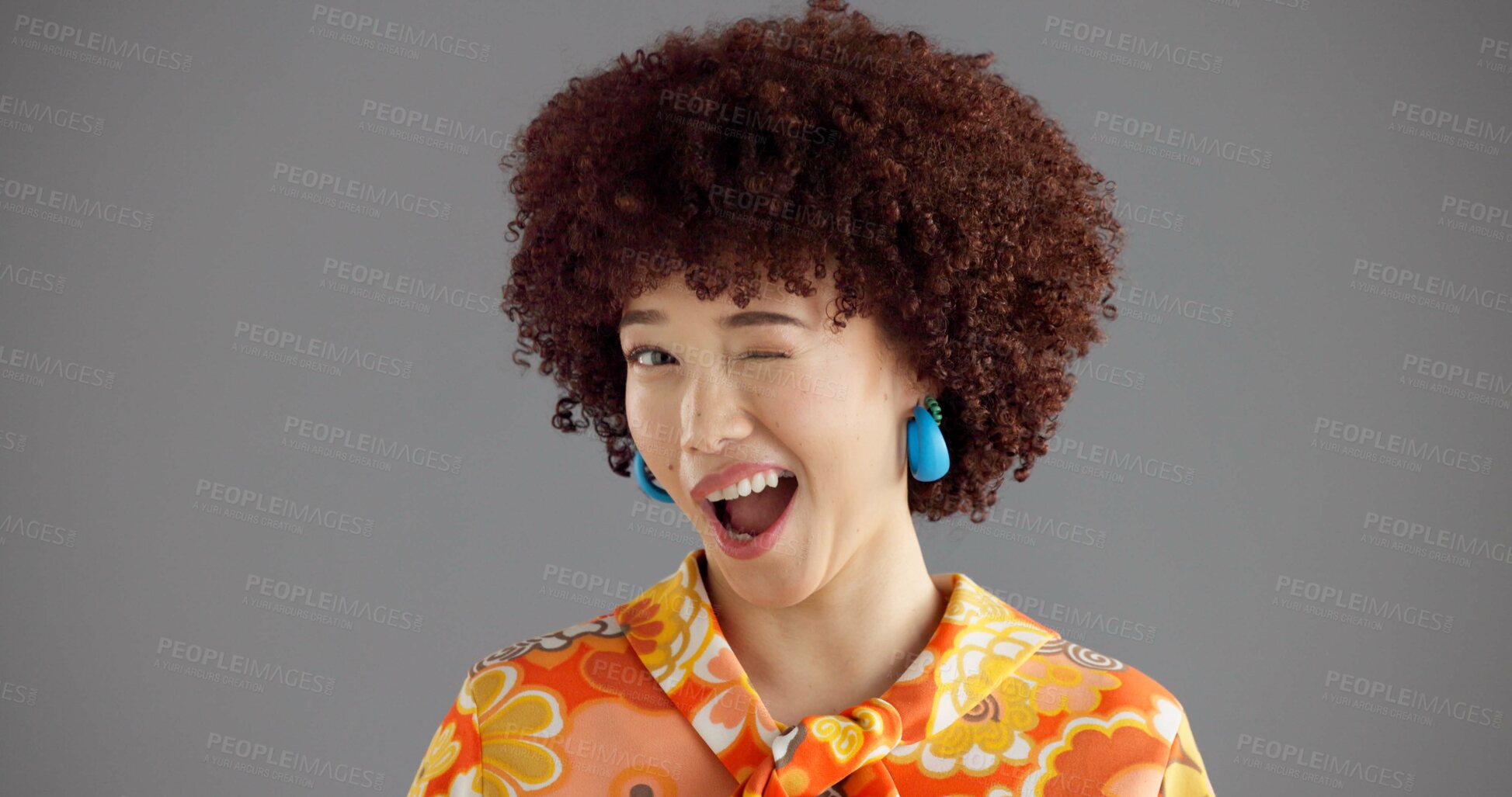 Buy stock photo Woman, wink and portrait in studio with retro style, smile and joke with secret deal on grey background. Girl, person and laughing with eye sign, vintage fashion and playful flirting expression