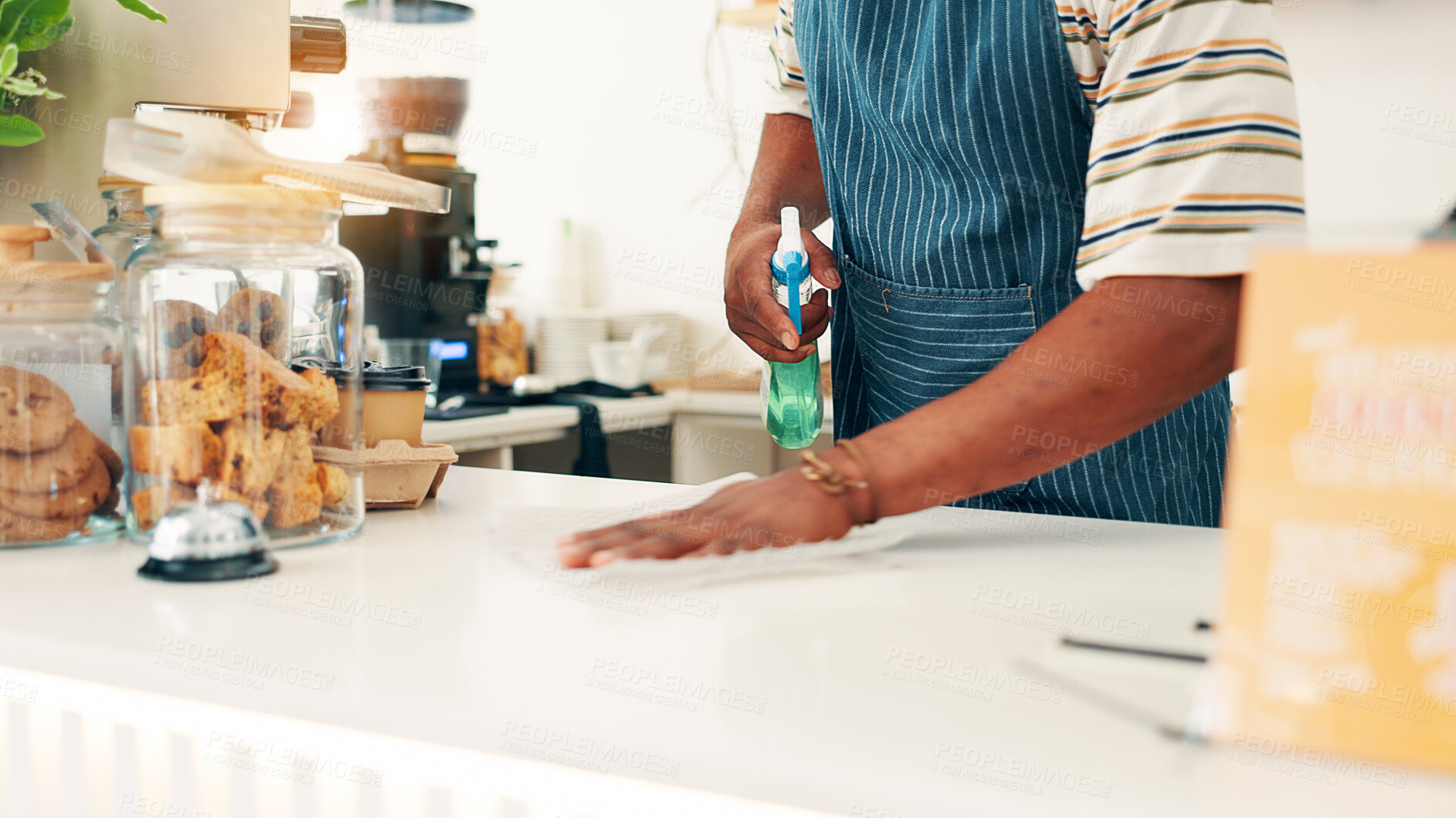 Buy stock photo Hands, cleaning countertop and man in cafe, spray bottle and disinfectant with maintenance. Closeup, employee compliance or person in coffee shop, safety policy or cloth to remove bacteria or hygiene