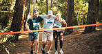 Marathon, people running and help to finish line for exercise aid, fitness and challenge together in forest. Mature team, runner and support for race with leg injury, sprain or tired at sports event