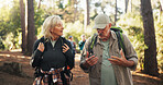 Talking, senior or couple on trail for hiking, outdoor adventure or journey in forest together. Relationship, exercise or people in woods for holiday retirement, walking or trekking to explore nature