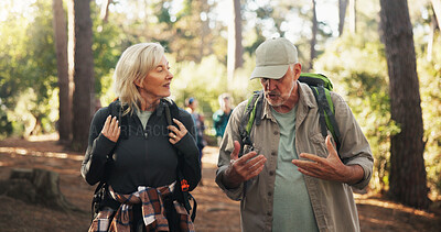 Buy stock photo Talking, senior or couple on trail for hiking, outdoor adventure or journey in forest together. Relationship, exercise or people in woods for holiday retirement, walking or trekking to explore nature