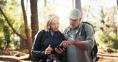 Buy stock photo Directions, map and phone with old couple in forest together to search for destination. App, lost and pointing at mobile with senior people outdoor in nature or woods for exercise, fitness or health