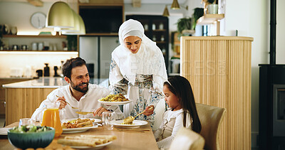 Buy stock photo Muslim, parents and child with food at house for Eid lunch, healthy meal and feast for celebration. Mother, serving and family dish for nutrition, religious event and cuisine of Islamic culture