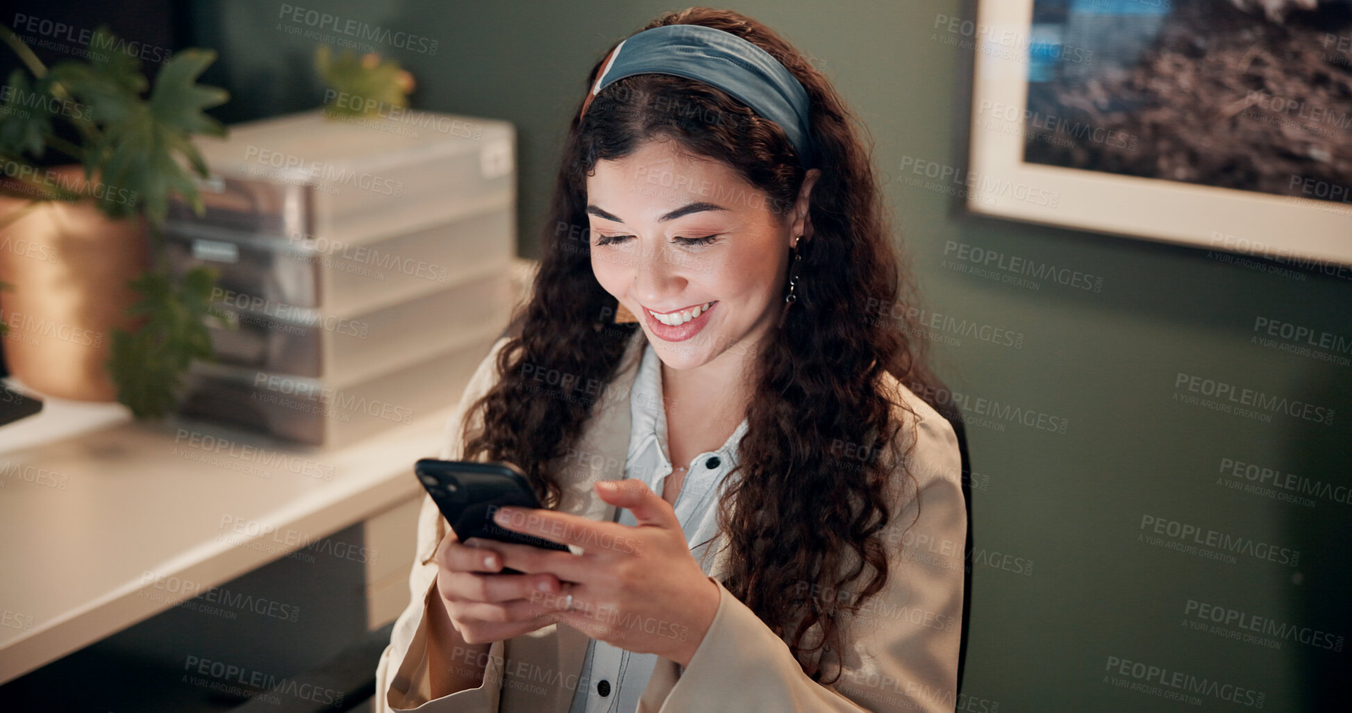 Buy stock photo Woman, phone and texting in office at night with smile, contact and scroll with notification for deal at company. Person, smartphone and happy with mobile app, chat and overtime at finance agency