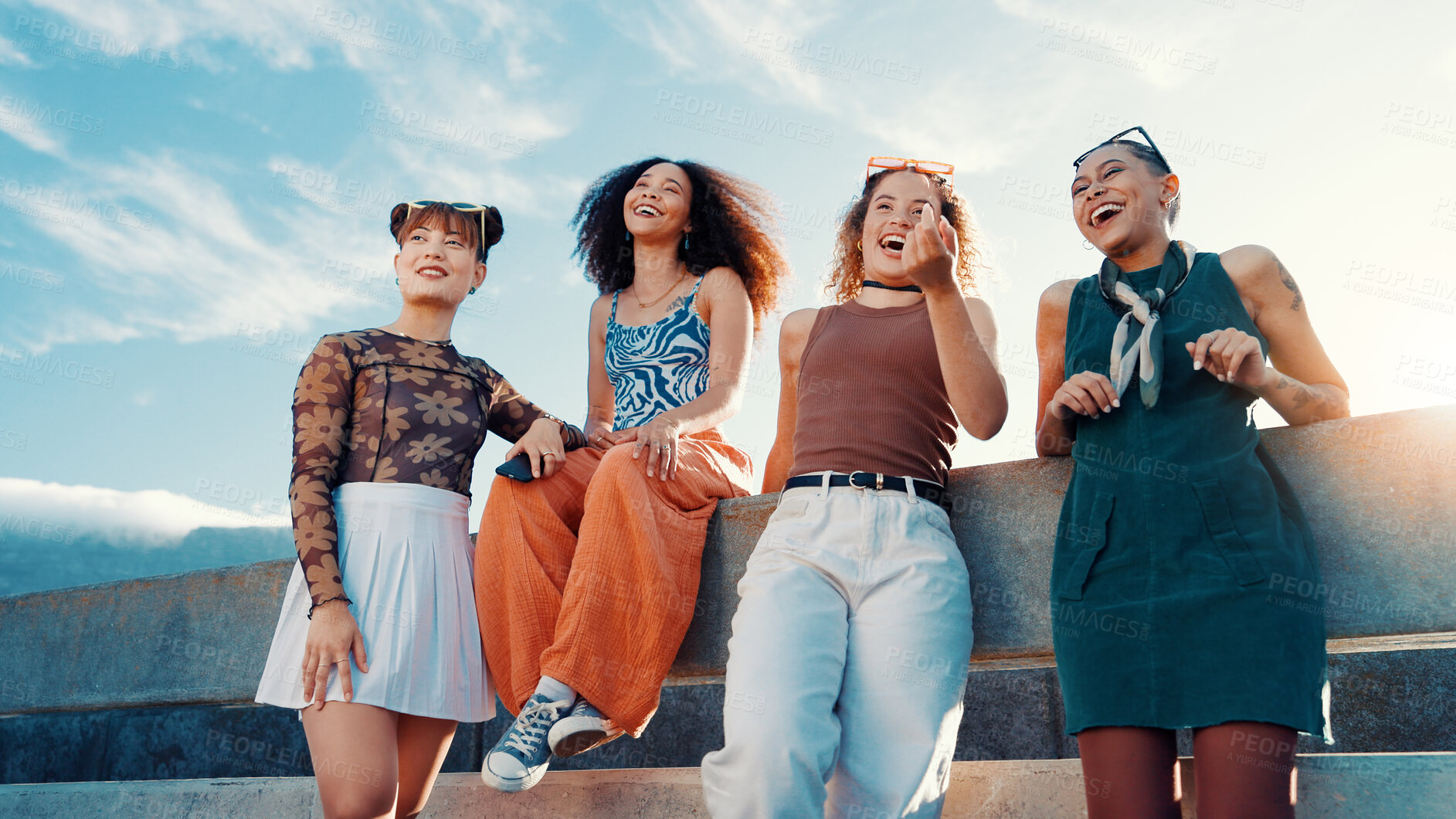 Buy stock photo Low angle, fashion and friends laughing in city on bridge in cool clothes, casual outfit or modern style. Relax, talking or trendy women with smile in urban town for holiday, streetwear or vacation