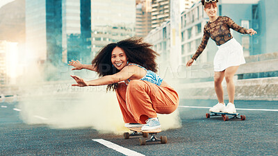 Buy stock photo Skateboard, smoke and freedom with friends in city for gen z youth, streetwear fashion and balance. Fitness, energy and Happiness with women skating in street for riding, hobby and action together