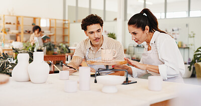 Buy stock photo Pottery, class and teacher and man with clay in workshop for teaching, learning and skills development. Creative, studio and woman with ceramic mold for design, sculpture and DIY hobby in art lesson