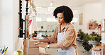 Packing, delivery and box with woman for small business, ceramic and product with shipping inspection. Sale, parcel and startup with order, shopping and customer information for supplier and shipment