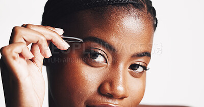 Buy stock photo Studio, portrait and woman with tweezer, grooming and plucking eyebrows in morning, beauty or self care. White background, facial treatment and black person with tool for hair removal, shape or Kenya
