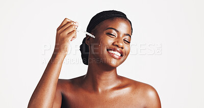 Buy stock photo Skincare, serum and woman with product, studio and moisturizing of face with liquid, hydration and smile. White background, happy and black person with cosmetics for treatment, glow and smooth skin