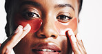 Black woman, portrait and eye patches with mask or hydration on a white studio background. Face, female person or model with facial gel or cosmetics for collagen, dermatology or anti aging treatment