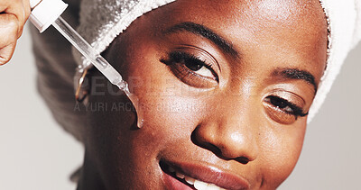 Buy stock photo Portrait, beauty and woman with serum, skincare and smile for smooth skin with routine and moisturizing. Gray background, hydration and black person with oil for treatment, studio and grooming