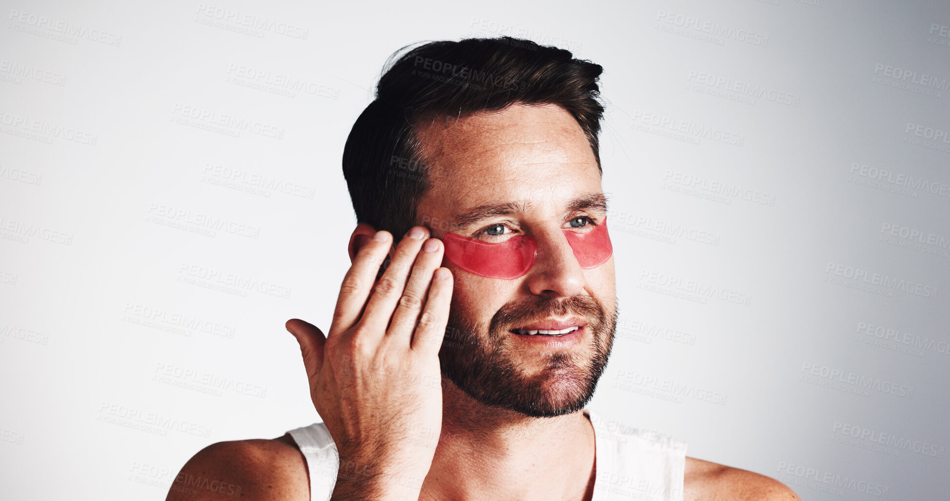 Buy stock photo Smile, skincare and eye mask with man in studio for dermatology, self care and anti aging treatment. Glow, collagen patch and beauty with mature person on white background for shine and facial