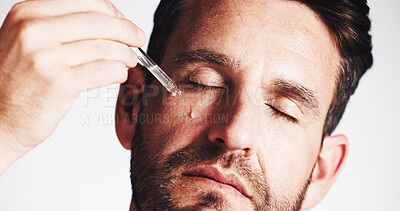 Buy stock photo Serum, beauty and glow with man in studio for skincare treatment, anti aging benefits and hydration. Collagen, shine and oil dropper with mature person on white background for cosmetics and self care