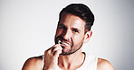 Portrait, man and brushing teeth for hygiene in studio for dental care, fresh breath and oral health. Male person, toothbrush and treatment for plaque removal, whitening benefits and white background