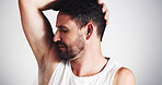 Studio, grooming and smelling of underarm, man and sniffing of odor in morning, cosmetics and deodorant. Clean, scent and person with routine for hygiene, white background and treatment for armpit