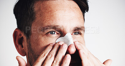 Buy stock photo Facial, skincare and nose strip with man in studio for beauty, spa treatment and dermatology. Cosmetics, self care and pore cleaning benefits with closeup of person on white background for glow