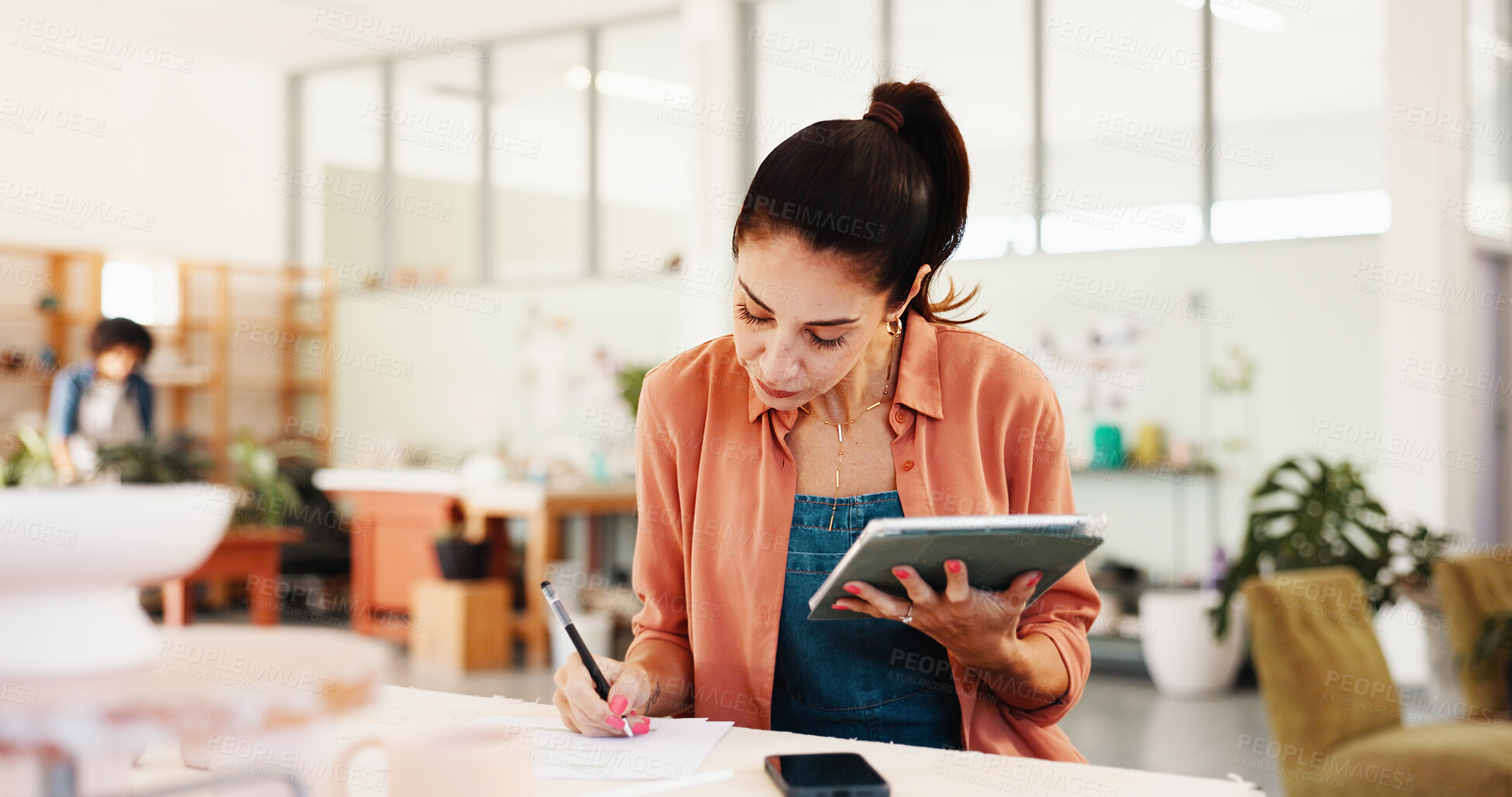 Buy stock photo Potter, writing and woman with tablet in workshop for inventory management, pottery schedule and online order. Small business, owner and digital checklist for clay supply and sales tracking in studio