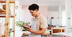 Ceramic, pottery and man with tablet in studio for inventory management, product inspection and quality control. Startup, potter and digital checklist for stock supply and pricing invoice at shelf