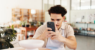 Buy stock photo Pottery, man and phone with picture in studio for social media post, creative website and sculpture lesson memory. Workshop, smartphone and person with photo for ceramic clay pot and online art app