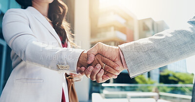 Buy stock photo Business people, city and handshake with partnership for B2B deal, agreement or meeting. Closeup, employees or colleagues shaking hands with lens flare for greeting or introduction in an urban town
