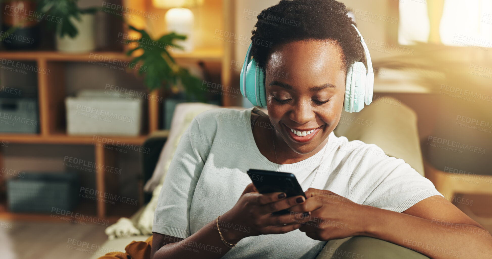 Buy stock photo Headphones, black woman and happy with phone on sofa for streaming subscription, music playlist and search song. Relax, person and smartphone for social media video and listening to podcast in home