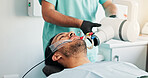 Appointment, consulting or x ray with dentist and patient in office for assessment or checkup. Equipment, healthcare and mouth of man in clinic with dental professional for exam or oral hygiene
