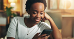 Black woman, smile and relax with phone in home for social media scroll, reading online news and streaming service. Night, person and internet connection on sofa for dating site browse and blog post