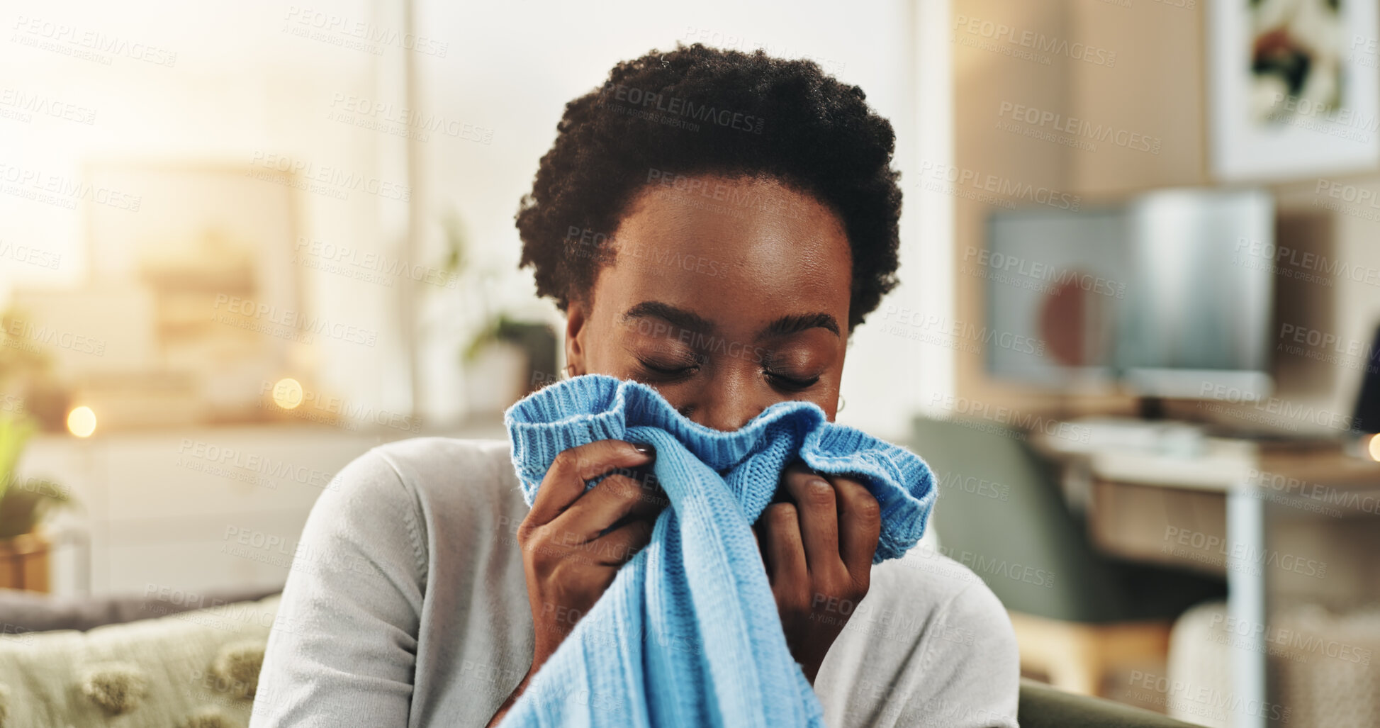 Buy stock photo Black woman, fabric and laundry with smell in home for clean washing, housekeeping or chores. Female person, maid or cleaner with clothing softner on sofa for fragrance, hygiene or comfort at house