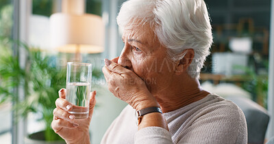 Buy stock photo Senior woman, water and medicine in home for healthcare, wellness and treatment. Glass, drink and elderly person with medication for prescription supplement, vitamin c pills and hydration in lounge