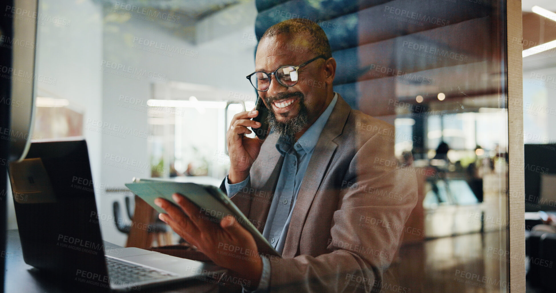 Buy stock photo Laptop, phone call and tablet with business black man in pod for communication or update. App, computer and conversation with mature employee in cubicle for accounting, feedback or hybrid work