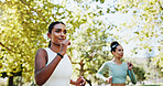 Women, running and workout in park with teamwork, exercise or support for endurance. Athlete, runner friends and fitness with marathon, training or development in nature for wellness and health goal