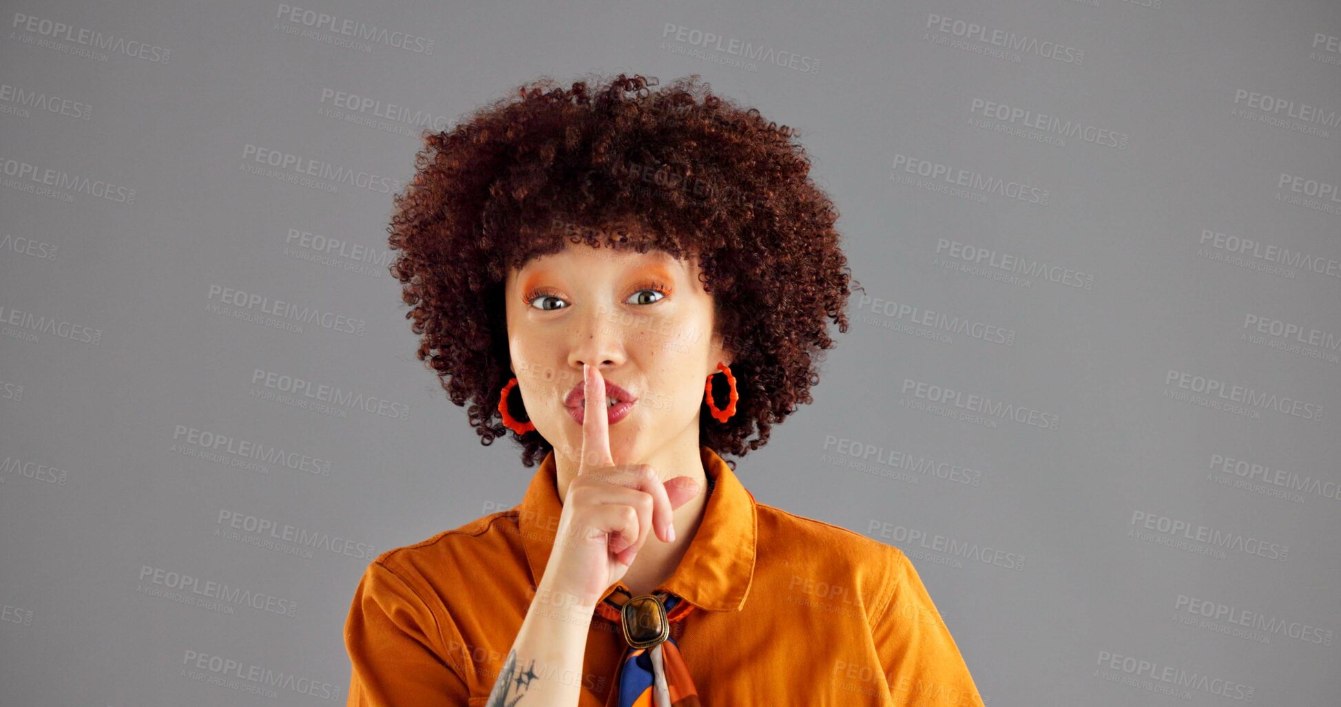 Buy stock photo Silent, finger and portrait of woman in studio for gossip, secret and privacy on gray background. Mockup space, emoji and isolated person with gesture for shh, noise or whisper for confidential news