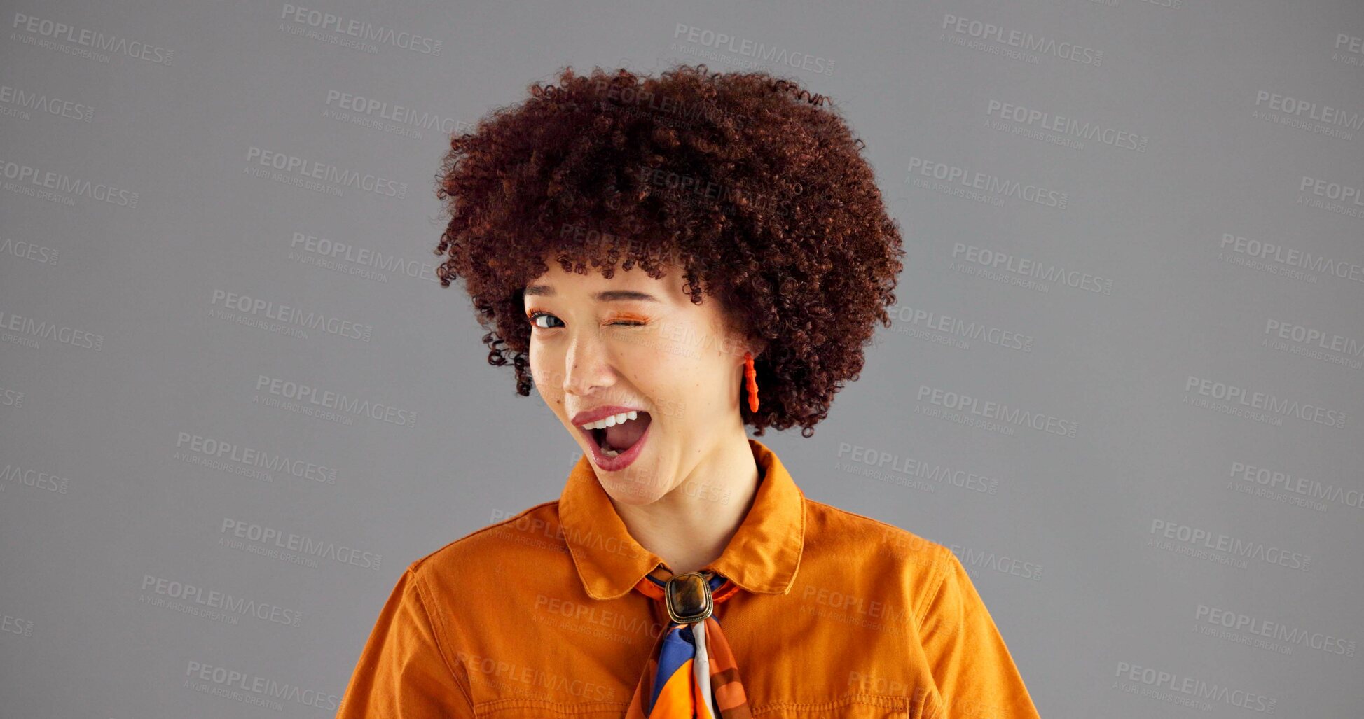 Buy stock photo Woman, smile and fashion with wink in studio portrait, flirt and playful with afro by background. Girl, model and happy with eye emoji, space or secret for retro style, confidence and pride in Brazil