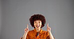 Portrait, excited woman and pointing up to space for advertising, mockup or discount deal. African person, marketing or presentation in studio for sales, promotion or special offer on gray background