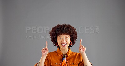 Buy stock photo Portrait, excited woman and pointing up to space for advertising, mockup or discount deal. African person, marketing or presentation in studio for sales, promotion or special offer on gray background
