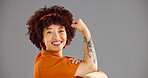 Portrait, flexing arms and woman with power, smile and win with confidence on grey studio background. Face, happy person and model with gesture, space or female empowerment with challenge or strong