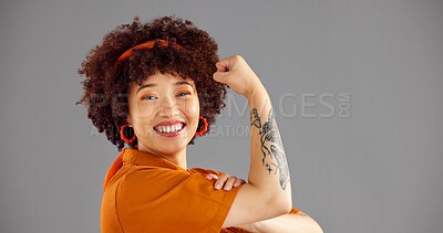 Buy stock photo Portrait, flexing arms and woman with power, smile and win with confidence on grey studio background. Face, happy person and model with gesture, space or female empowerment with challenge or strong