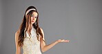 Portrait, open hand and woman in studio, option and questions on grey background. Face, person and model with gesture, choice and shrug with decision, comparison and offer with selection and opinion