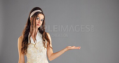 Buy stock photo Portrait, open hand and woman in studio, option and questions on gray background. Face, person and model with gesture, choice and shrug with decision, comparison and offer with selection and space
