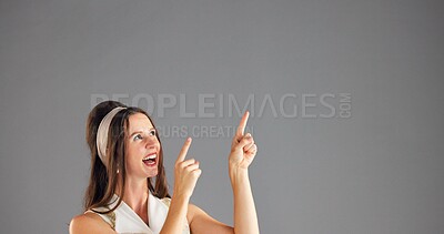 Buy stock photo Excited, woman and pointing up to space for advertising, mockup or discount deal. Happy person, marketing and presentation in studio for retro fashion sales, promotion or offer on gray background