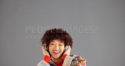 Buy stock photo Headphones, happy and woman in studio, listening to music and singing on gray background. Person, mockup space or model with confidence, radio and headset with audio, streaming sound and song