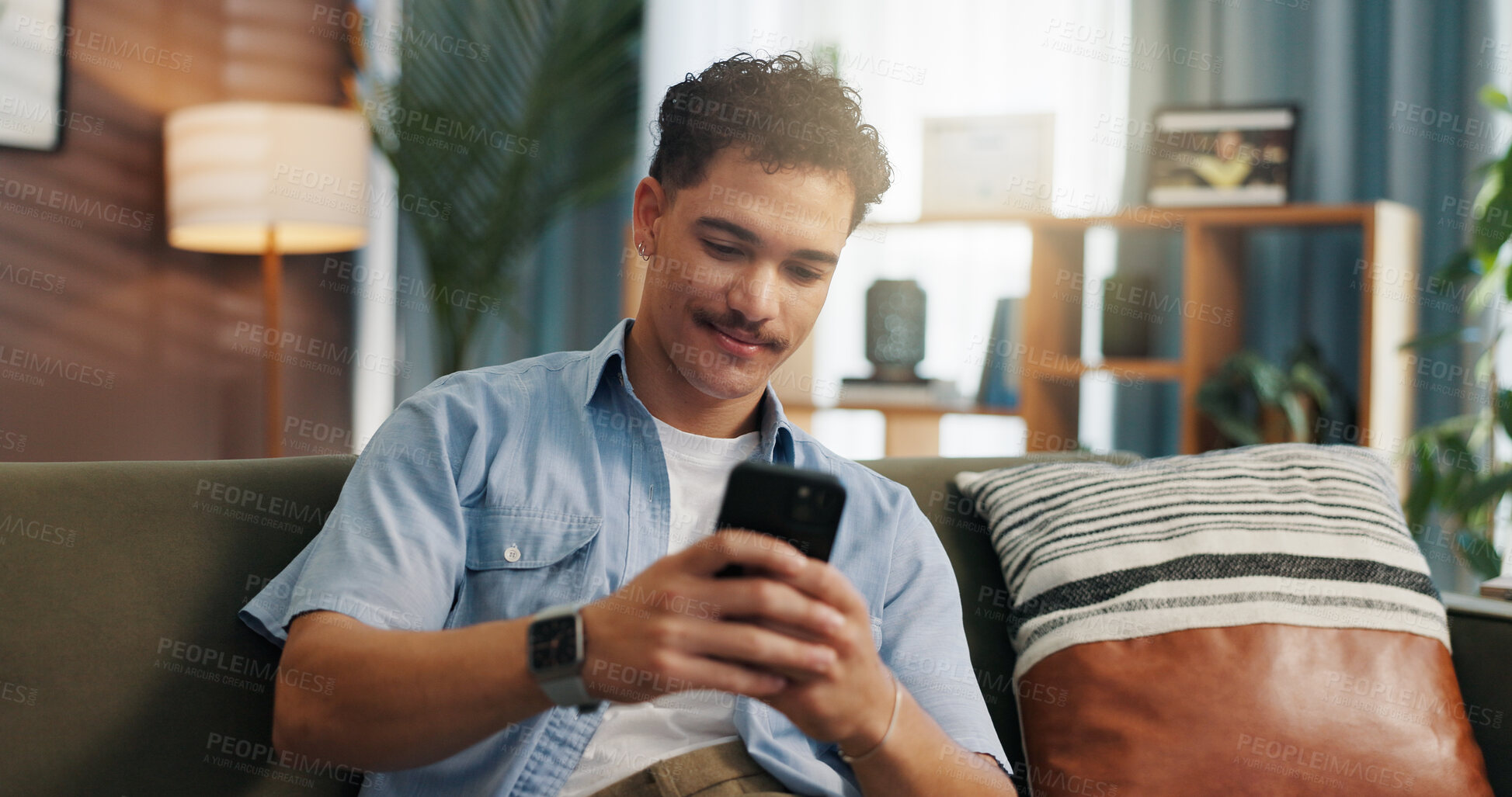 Buy stock photo Relax, smile and man with mobile on sofa for communication, chat and reading message. Home, online and happy person with smartphone for texting, social media and browsing website to download app